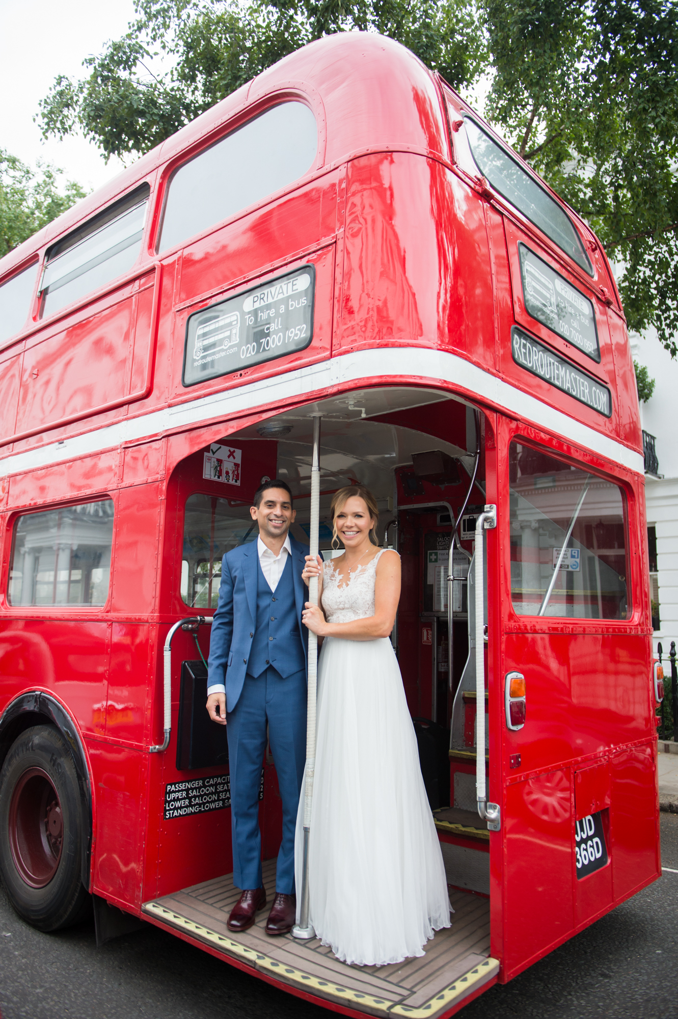 A bride and groom on a London red routemaster